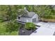 Side view of home featuring a two-car garage, mulch beds, and fresh concrete at 16 Maplecrest Dr, Carmel, IN 46033