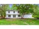 Front exterior of home with large front yard and big tree in the front at 16 Maplecrest Dr, Carmel, IN 46033