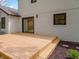 A light wood deck with steps leads to the backyard, featuring a brick exterior and dark trim windows at 16 Maplecrest Dr, Carmel, IN 46033