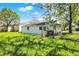 Backyard with a house, green grass, scattered trees and a chain link fence at 1610 S F St, Elwood, IN 46036