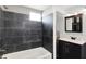 Updated bathroom with black tiled shower, sleek vanity, and modern fixtures at 1610 S F St, Elwood, IN 46036