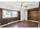 Bedroom with hardwood flooring, wood paneling, a window and an open closet at 1610 S F St, Elwood, IN 46036
