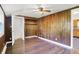 Bedroom with hardwood flooring, wood paneling, a window and an open closet at 1610 S F St, Elwood, IN 46036