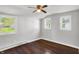 Bright bedroom featuring hardwood floors, a ceiling fan, and three windows at 1610 S F St, Elwood, IN 46036