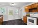 Bright kitchen featuring classic wood cabinets, tile countertops and a white range at 1610 S F St, Elwood, IN 46036