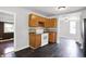 Functional kitchen featuring wood cabinets, white appliances, and tile backsplash at 1610 S F St, Elwood, IN 46036