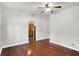Bright living room featuring hardwood floors, neutral walls and a hallway view to the kitchen at 1610 S F St, Elwood, IN 46036