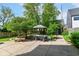 Backyard with outdoor dining set, mature trees, lush green grass and privacy fence at 1630 N New Jersey St, Indianapolis, IN 46202