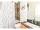 Cozy bathroom features a shower-tub combination, tile walls, framed mirror and vanity sink at 1630 N New Jersey St, Indianapolis, IN 46202