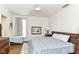 Bright bedroom featuring hardwood floors, a bed with patterned blue cover, and a window at 1630 N New Jersey St, Indianapolis, IN 46202