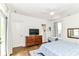 Bright bedroom featuring hardwood floors, balcony access and a wood dresser with mounted television at 1630 N New Jersey St, Indianapolis, IN 46202