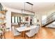 Dining room with modern light fixture, open to living room, and staircase with open floor plan at 1630 N New Jersey St, Indianapolis, IN 46202