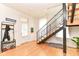 Bright entryway with hardwood floors, black metal staircase, coat rack, and natural light at 1630 N New Jersey St, Indianapolis, IN 46202