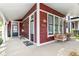 Inviting front porch with wicker furniture and a 'Welcome' mat leading to the front door at 1630 N New Jersey St, Indianapolis, IN 46202