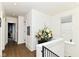 Bright hallway with natural light and hardwood floors leading to various rooms and stairs at 1630 N New Jersey St, Indianapolis, IN 46202