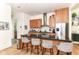 Modern kitchen features a functional island with seating, granite counters, and stainless steel appliances at 1630 N New Jersey St, Indianapolis, IN 46202