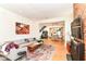 Bright and airy living room featuring an exposed brick fireplace and seamless flow to the dining area at 1630 N New Jersey St, Indianapolis, IN 46202