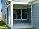 Covered back patio with blue siding, white trim, and a lush green lawn at 1679 W 171St St, Westfield, IN 46074