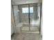 Bathroom features a glass-enclosed shower with a bench and marble floors at 1679 W 171St St, Westfield, IN 46074