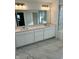 Bathroom features double sinks, a large mirror and marble floors at 1679 W 171St St, Westfield, IN 46074