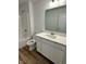 Bathroom featuring wood-look flooring, white cabinets, and a shower and tub combination at 1679 W 171St St, Westfield, IN 46074