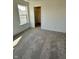 Bright, neutral bedroom with gray carpet, white walls, trim, and a bright window at 1679 W 171St St, Westfield, IN 46074