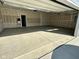 Spacious two-car garage interior featuring concrete flooring, ample lighting, and a service door at 1679 W 171St St, Westfield, IN 46074
