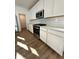 Modern kitchen features stainless steel appliances, white cabinetry, and a bright, open layout at 1679 W 171St St, Westfield, IN 46074