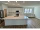 Gourmet kitchen with white cabinets, quartz countertops, a large island and stainless appliances at 1679 W 171St St, Westfield, IN 46074