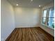Bright empty room with recessed lights and vinyl floor plus a large window overlooking the yard at 1679 W 171St St, Westfield, IN 46074