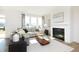 Bright living room with a fireplace, neutral tones, large windows, and comfortable seating area at 175 Rock Island Rd, Westfield, IN 46074