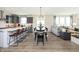 Bright open-concept living area with kitchen, dining space, and comfortable seating near large windows at 175 Rock Island Rd, Westfield, IN 46074