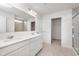 Bright bathroom with dual sinks, quartz countertops, modern fixtures, and tile flooring at 18943 Seaforth Way, Westfield, IN 46074