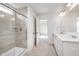 Modern bathroom with a glass-enclosed shower, dual sinks, and tile flooring at 18943 Seaforth Way, Westfield, IN 46074