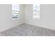 This bedroom features carpet flooring, natural light from two windows, and neutral walls at 18943 Seaforth Way, Westfield, IN 46074