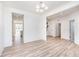 Open-concept dining room showcasing hard surface floors, a modern light fixture, and bright white walls at 18943 Seaforth Way, Westfield, IN 46074