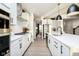 Modern kitchen with white cabinets, stainless steel appliances, and a center island with seating at 18943 Seaforth Way, Westfield, IN 46074