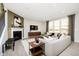Bright living room features a fireplace, modern furniture, and large windows offering scenic views at 18943 Seaforth Way, Westfield, IN 46074