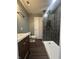 Modern bathroom featuring walk-in shower with dark tiled walls and sleek fixtures at 2009 Draper St, Indianapolis, IN 46203