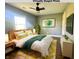 Bright, staged bedroom with ceiling fan, and large windows to allow in natural light at 2009 Draper St, Indianapolis, IN 46203