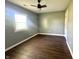 Empty bedroom with hardwood floors, neutral colored walls, a ceiling fan and windows at 2009 Draper St, Indianapolis, IN 46203