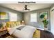 Bright, staged bedroom with ceiling fan, and large windows to allow in natural light at 2009 Draper St, Indianapolis, IN 46203