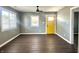 Bright and airy living room featuring beautiful wood floors and a striking yellow door at 2009 Draper St, Indianapolis, IN 46203
