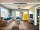 Virtually staged living room with modern furniture, wood floors, and a bright yellow door at 2009 Draper St, Indianapolis, IN 46203