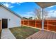 Backyard features a wood privacy fence, a well manicured lawn, and a detached garage at 2013 Yandes St, Indianapolis, IN 46202