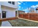 Backyard view with a brown fence and green grass, and house exterior at 2013 Yandes St, Indianapolis, IN 46202