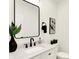 Modern powder room featuring a sleek mirror, black fixtures, and contemporary vanity at 2013 Yandes St, Indianapolis, IN 46202