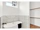 Elegant bathroom featuring a soaking tub, marble tile, and modern lighting at 2013 Yandes St, Indianapolis, IN 46202