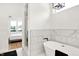 Luxury bathroom featuring a soaking tub, shower, and view into a bedroom at 2013 Yandes St, Indianapolis, IN 46202