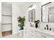 Modern bathroom with double sink vanity, large mirrors, and elegant fixtures at 2013 Yandes St, Indianapolis, IN 46202